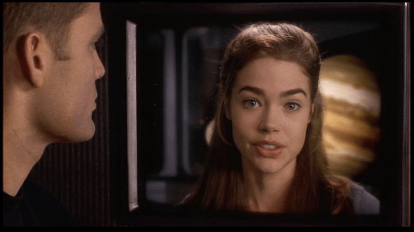 Close-up of Johnny watching a video Carmen: he looks screen right from the left third of the frame and she is facing the camera