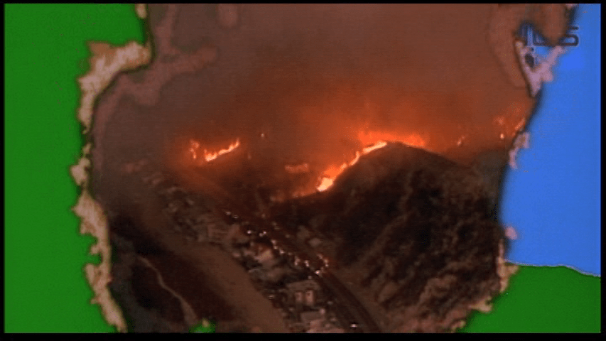 Continuation of the previous shot: the map gives way to flames and destruction