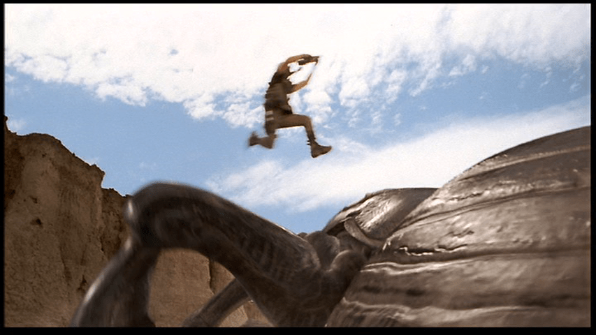 Long shot of Johnny leaping onto a Tanker Bug