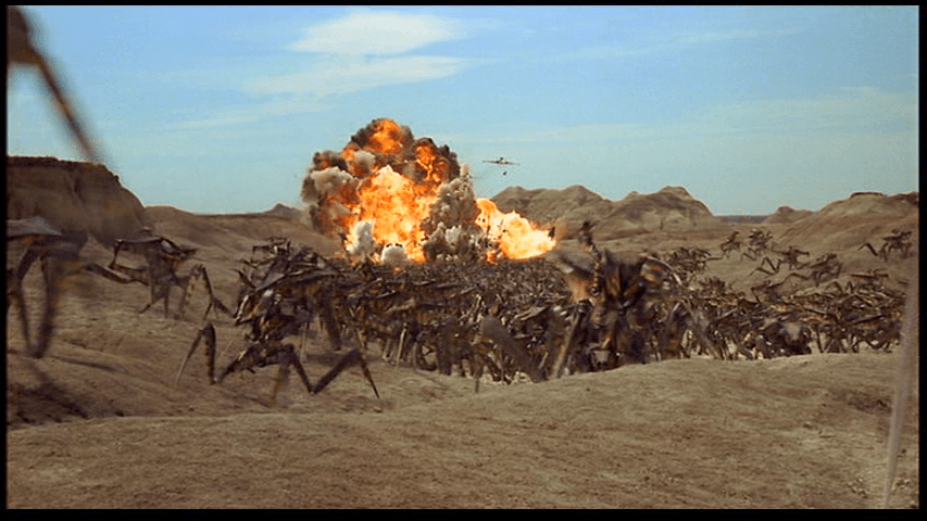 Long shot of bombers strafing a column of Bug warriors