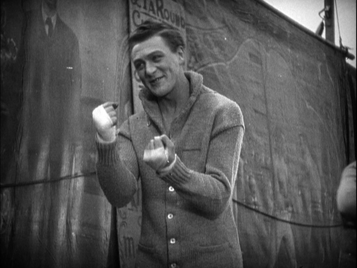 Medium shot of Sander pantomiming boxing