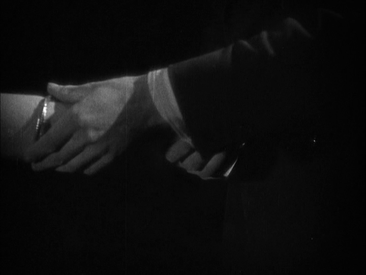 Close-up of Corby sliding a bracelet onto Mabel's list