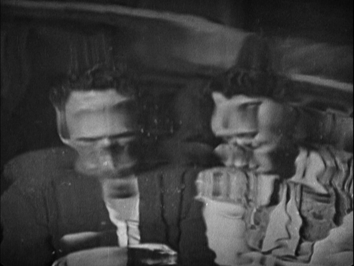 Medium shot of Sander's and Mabel's reflections in the pond, distorted by ripples