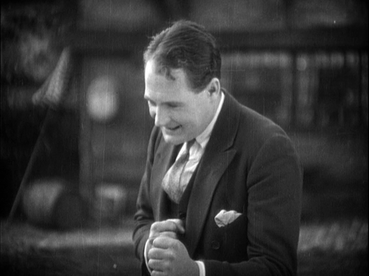 Medium shot of Corby pantomiming boxing