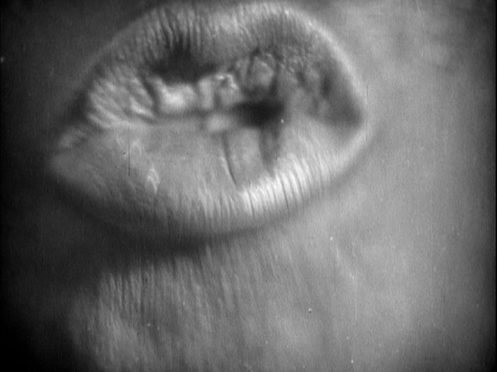 Extreme close-up of pursed lips in mid-shout