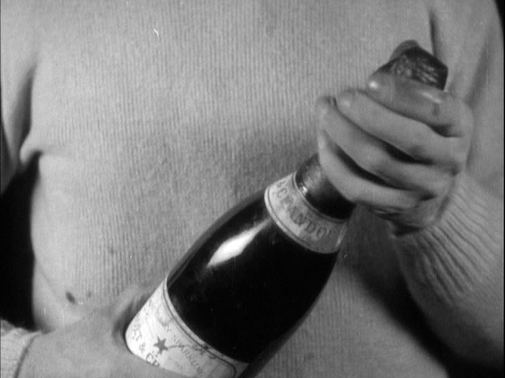 Close-up of a cornerman opening a bottle of champagne