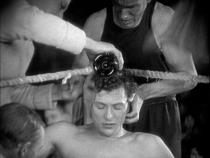 Medium shot of said cornerman pouring the champagne over Sander's head