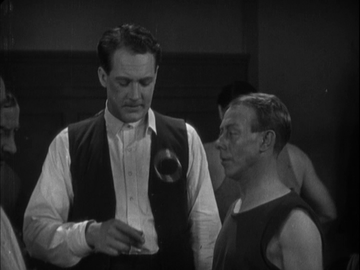 Medium shot of Corby flipping the bracelet back to the person who found it