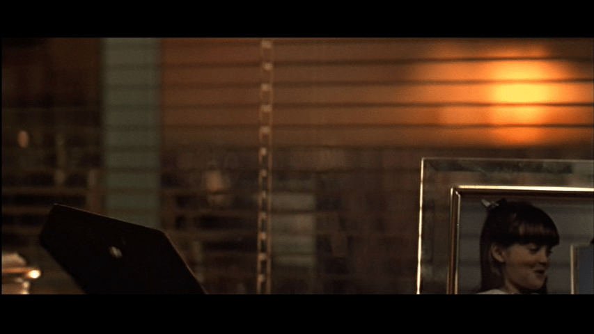 Continuation of the previous shot: the photo, which Holly has turned down, has disappeared from the frame