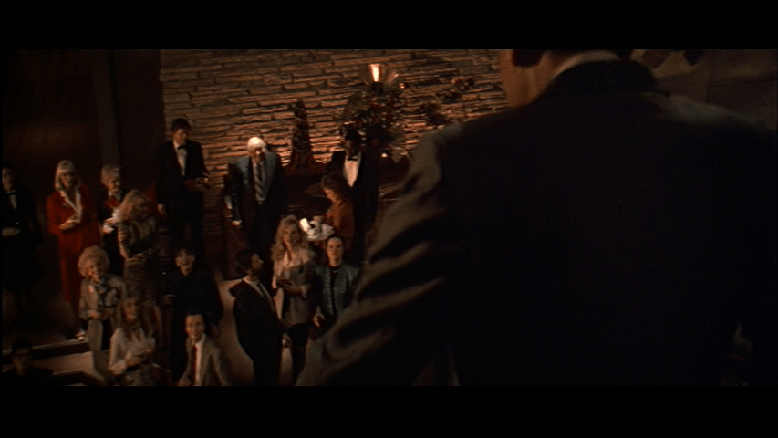 Continuation of the previous shot: the camera has moved in just a bit on Holly in the middle of the frame; Takagi now occupies the entire right side of it