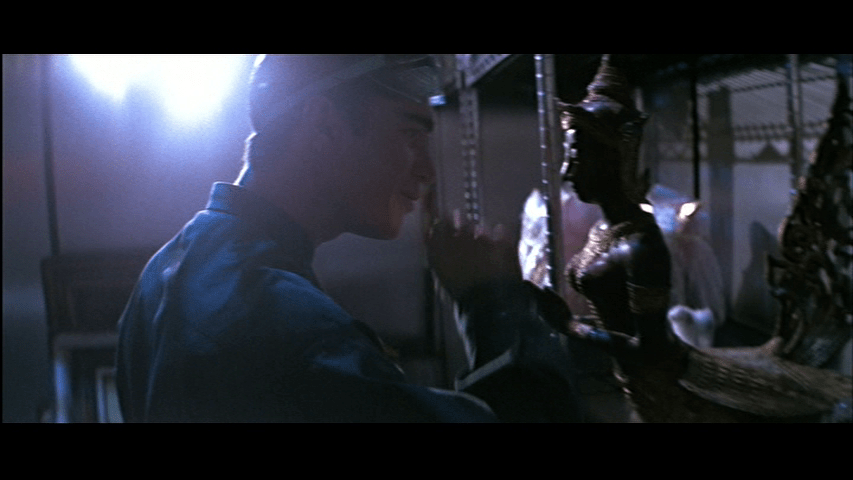 Medium shot of Kristoff (Gérard Bonn) flicking a statue with his finger