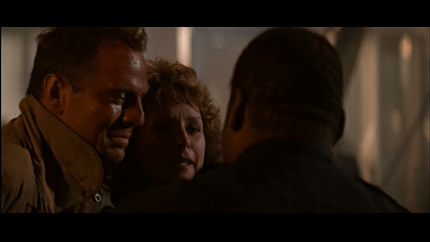 Close-up of Holly speaking to Al, whose back is to the camera, from McClane's side