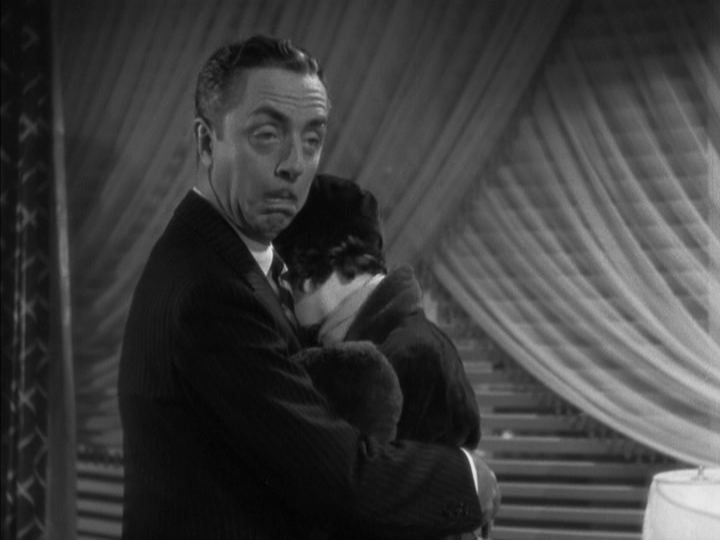 Medium shot of Nick still holding Dororthy, but now making a funny face at his wife