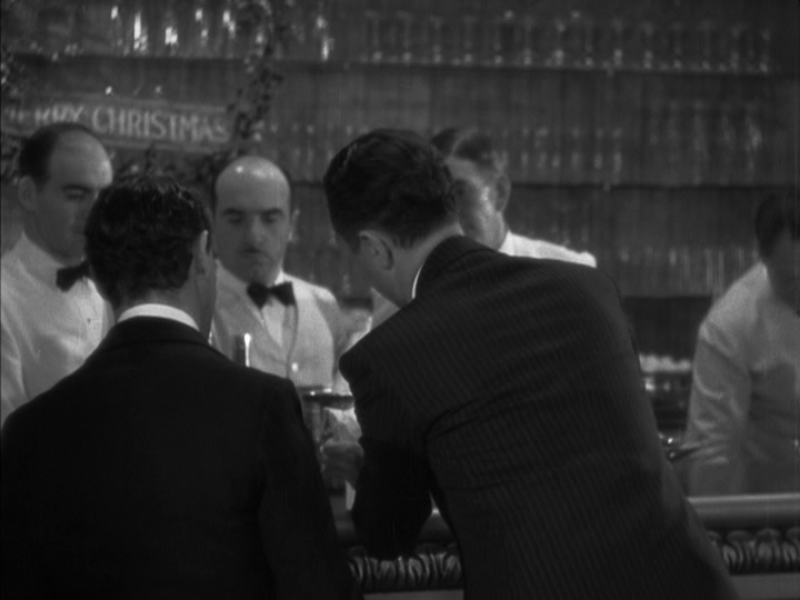 Continuation of the previous three images: Nick strains the cocktail shaker he's been holding into a glass we can't quite see