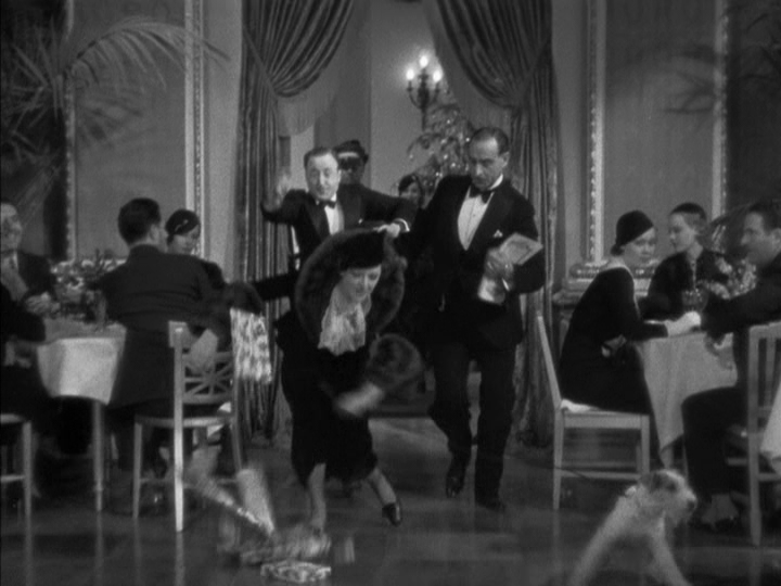 Nora lurches forward as the presents fly all over the room with two waiters running after her