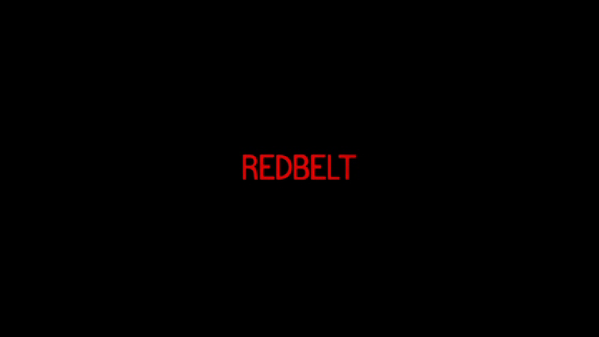 Title card that reads "Redbelt" in a striking red-tinted all caps sans serif font