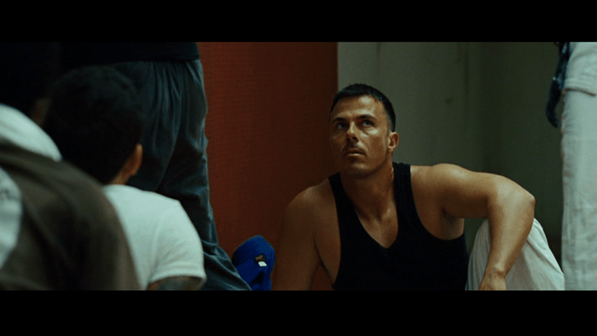 Medium close-up of a student looking up at Mike, whose legs are just barely visible in the far right edge of the frame