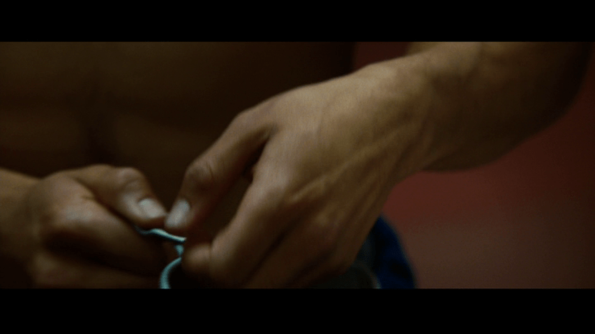 Close-up of hands placing the marbles in the cup