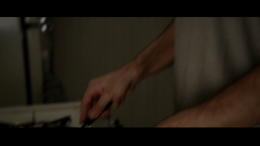Close-up of Nate's hands and torso blurred by camera movement