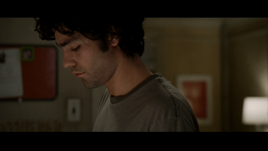 Continuation of the previous image: the camera has come to rest on Nate's face as he looks down from the center of the frame