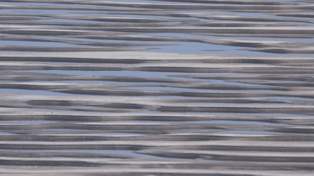 Striking assembly of gray, white, and frosty blue horizontal lines that looks like it could be an Arctic landscape but maybe not?
