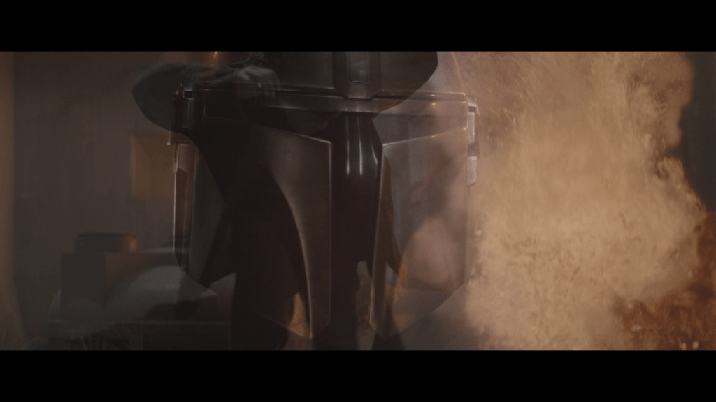 Close-up of the Mandolorian's helmeted face superimposed over both flames from a violent episode in his youth and the Armorer hammering