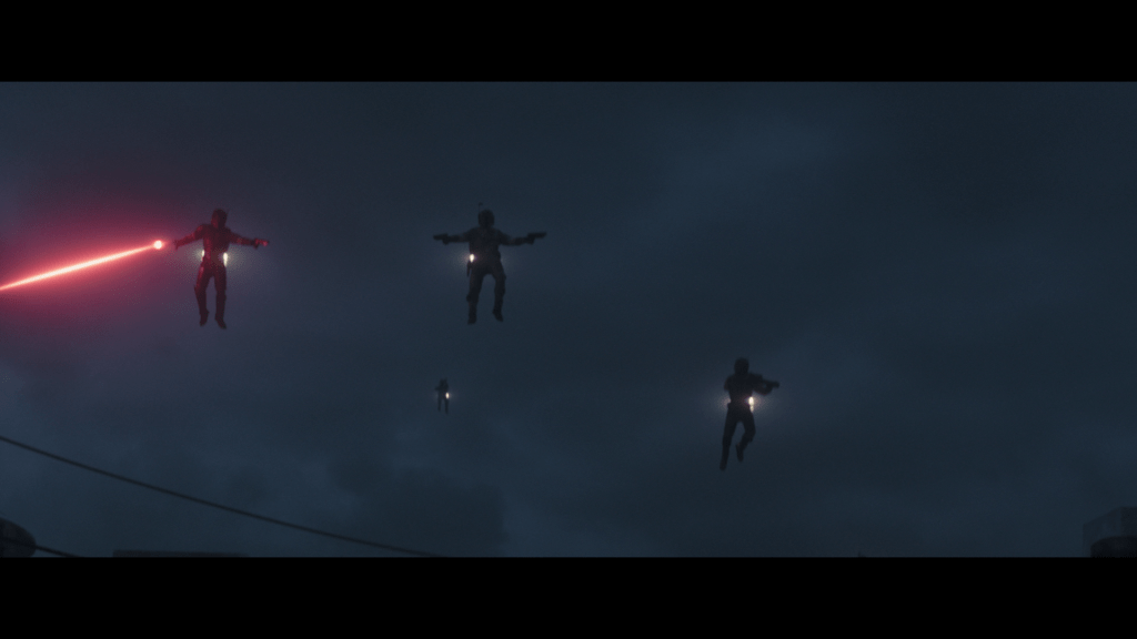 Low-angle long shot of flying Mandalorians coming to the rescue