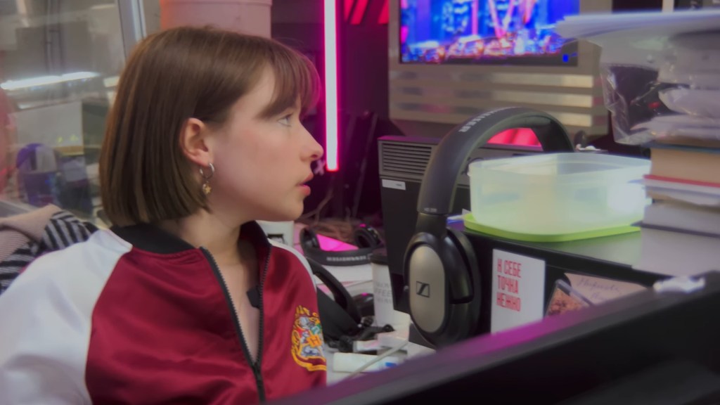 Medium shot of Ksenia at her computer in a Hogwarts jacket