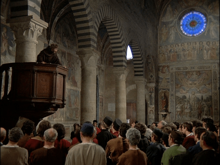 Low-angle shot of a monk preaching amidst wonders of art and architecture paid for by Cosimo de' Medici'