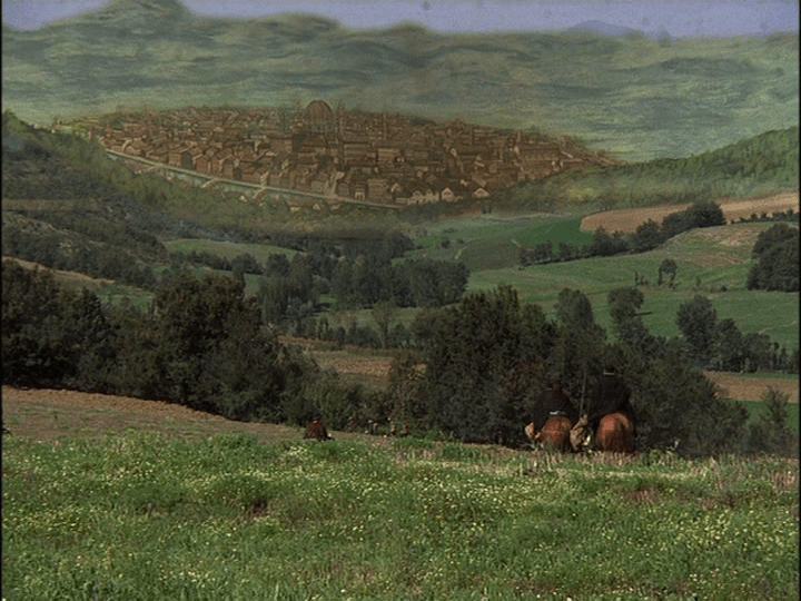 Establishing shot of three men on horseback riding over verdant hills toward a painted backdrop of Renaissance Florence that is nearly seamlessly incorporated into the frame