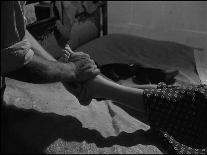 Continuation of the previous image: Spartaco holds his wife's feet in a embrace that appears loving even though we can't see either of their faces