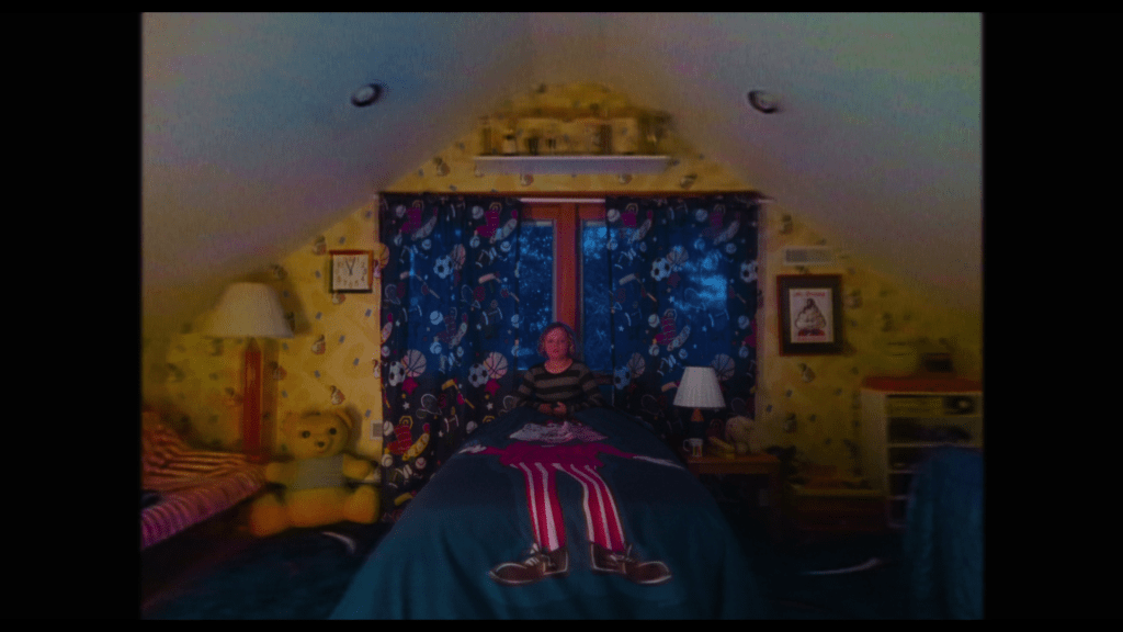 Long shot of a child in their bed, frozen in fear