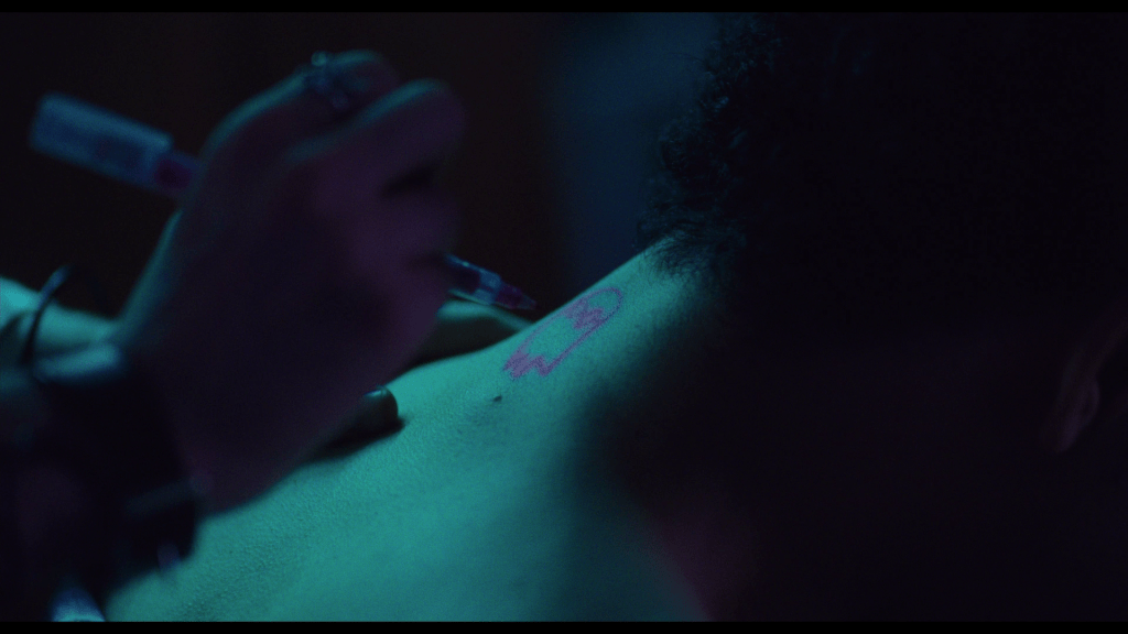 Close-up of Maddy drawing the ghost-shaped birthmark from The Pink Opaque on the back of Owen's neck