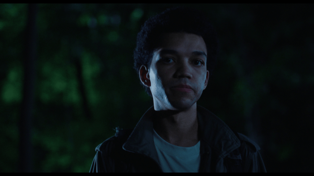 Medium shot of Owen looking offscreen from the center of the frame
