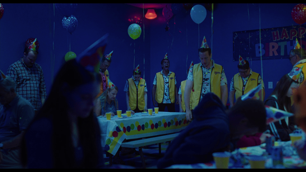 Long shot of Owen screaming while all of his co-workers and customers just go limp