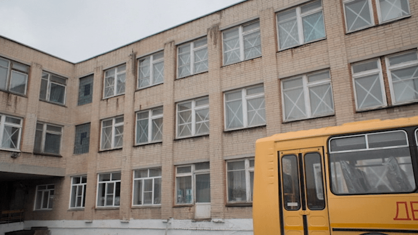 Long shot of the exterior of Pavel Talenkin's school showing the X's he has taped over all the windows