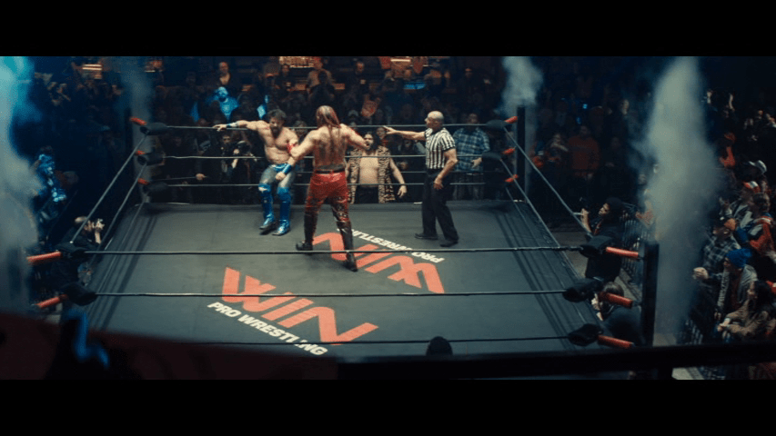 Long shot of the wrestler from the previous image and his opponent in the ring