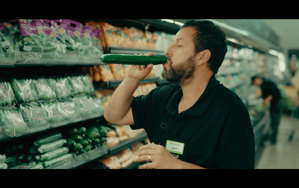 Medium shot of Happy Gilmore drinking out of a cucumber