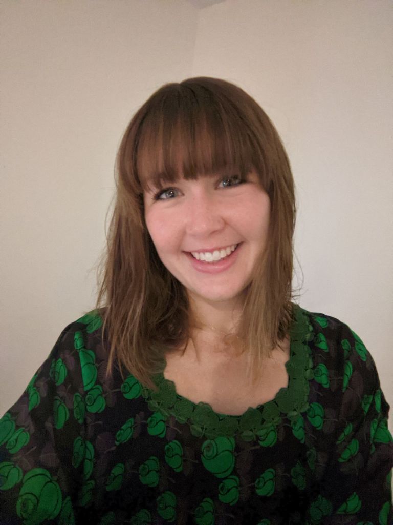 Headshot of Cornell Cinema Director Molly Ryan in a green top