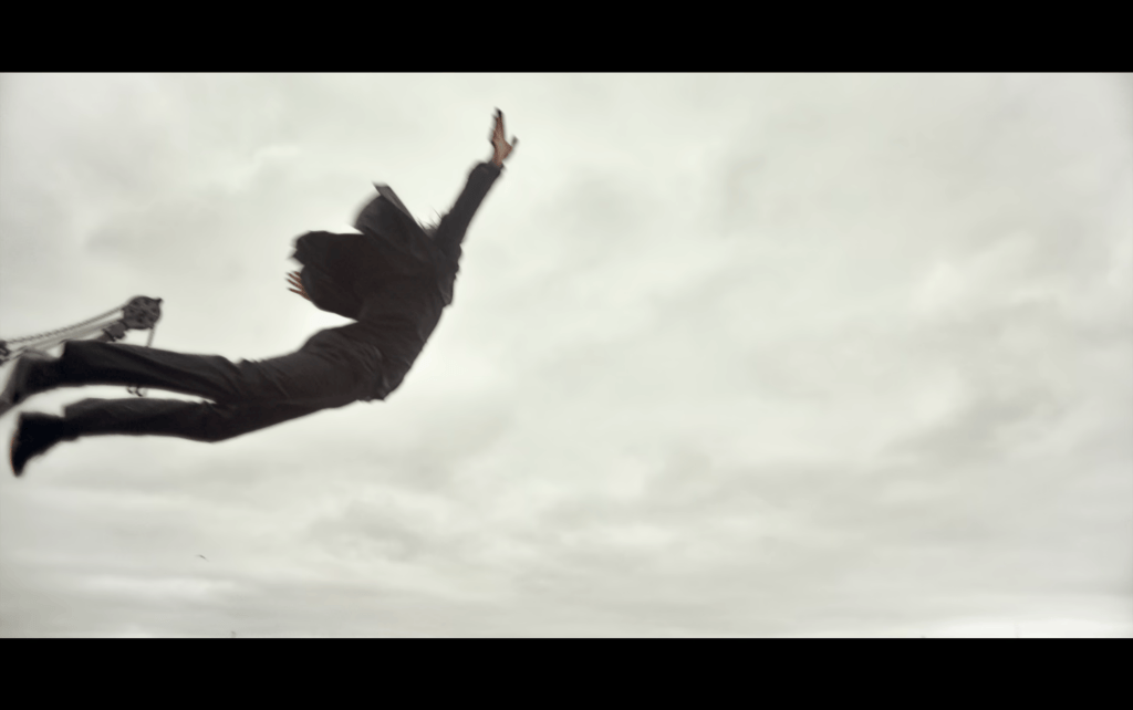 Long shot of Martin suspended in mid-air as he dives into Copenhagen Harbour