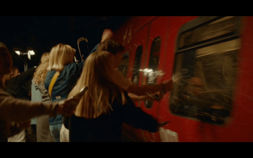 Medium long shot of beers spraying a light rail car with beer