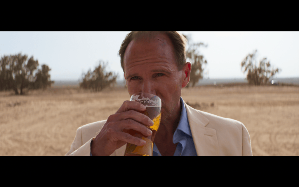Close-up of David drinking a pint of beer