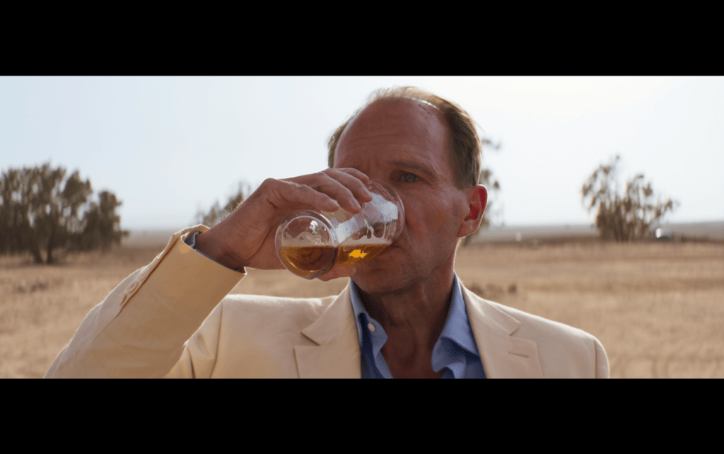 Continuation of the previous image: David tilts the glass, which is now half empty, back
