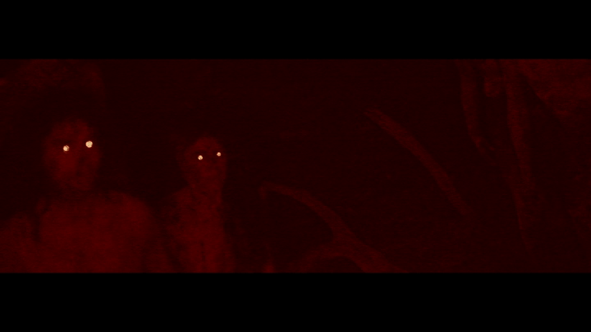Continuation of the previous image: the infected who follow Samson look on as he holds up the deer's head in the right foreground, the light reflecting eerily off their eyes